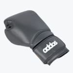 A single dark grey boxing glove with a white addos logo on the wrist strap, isolated on a white background.