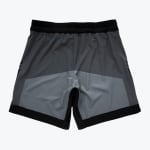 Back view of men athletic shorts with a grey and black color-block design on a white background.