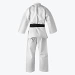 Rear view of a white martial arts gi with a black belt tied around the waist, isolated on a white background.
