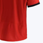 Close-up view of the back and side panel of a red athletic shirt, showing curved stitching details and a short sleeve with a black cuff.