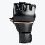 A single black fingerless MMA glove with gold trim, showing the padded knuckle area and wrist strap against a white background.