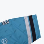 A close-up view of a light blue jersey sleeve with repeating Adidas wordmarks, featuring a white and black stripe at the cuff.