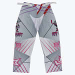 A front view of gray, white, and pink inline hockey pants with Saucy Fights Cancer logos and cartoon graphics on a plain white background.