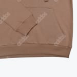 Close-up of a brown Addos hoodie showing the ribbed cuff, hem, kangaroo pocket, and faint all-over Addos logo pattern.