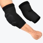 A pair of black padded elbow sleeves, with one worn on a person arm showing the protective padding and the other shown separately to display the inner elbow cutout.