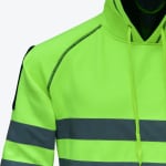 Close-up of a neon green high-visibility safety hoodie with reflective silver stripes and black stitching.