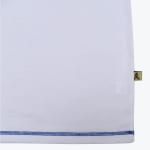 Close-up of a white shirt hem with blue stitching and a small gold tag with a star logo on the side.