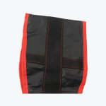 Close-up of a black nylon sandbag with red stitched borders and a central black webbing strap.