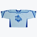 A light blue hockey jersey with a central logo reading Ice-O-Topes over an iceberg graphic, set against a plain white background.