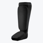 A black slip-on shin and instep guard for martial arts training, shown against a plain white background.