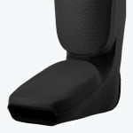 Close-up of a black padded shin and instep guard on a white background.