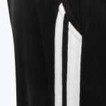 Close-up view of black velour fabric with two vertical white stripes on the side.