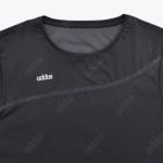 Close-up of a black crew neck athletic shirt featuring a white Addos logo on the chest and a diagonal panel design.