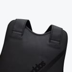 Close-up of a black Addos martial arts chest guard showing the shoulder straps and neckline.
