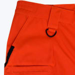 Close-up of bright orange work pants showing a waistband, belt loop with a black D-ring, and side pockets.