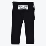 Back view of black martial arts pants with a white patch on the seat reading TRAPXJITSU Bushido Code.