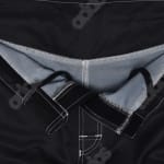 Close-up of the front closure of black athletic shorts featuring a Velcro flap, white stitching, and internal drawstrings.