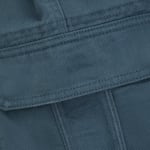 Close-up of a teal-blue twill fabric pocket flap with double-stitched edges.