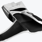 Close-up view of the inner palm of a white and black MMA grappling glove against a white background.
