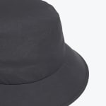 A close-up view of a dark grey bucket hat showing the crown, brim, and stitching details on a white background.