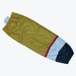 A flat-lay image of a gold glitter patterned sleeve with red, white, and navy blue stripes and elastic cuffs.