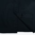 A close-up view of a black button-down shirt showing the button placket and bottom hem.