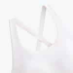 Close-up of the criss-cross straps on the back of a white sports bra.