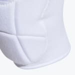 Close-up view of a white padded sports sleeve showing the textured fabric and stitched protective panels.