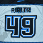 The back of a light blue sports jersey with the name BIALEK and the number 49 in black and blue stylized font.