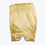 A pair of shiny gold satin boxing shorts with a thick elastic waistband and a side slit on a white background.