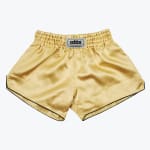A pair of gold satin Muay Thai shorts with a black trim and an elastic waistband against a white background.