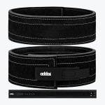 Three views of a black suede Addos weightlifting belt with a black lever buckle and white stitching, displayed against a light grey background.