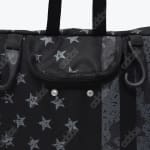 Close-up of a black Addos bag with a grey star print, a zippered pocket, and side hooks.
