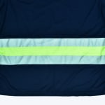 Close-up of a navy blue safety garment showing a horizontal reflective band with a lime green stripe in the middle and silver diagonal-striped reflective tape on the top and bottom.