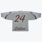 The back of a light grey hockey jersey with white shoulders, featuring the number 24 and the word Zodiac in dark red.