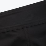 Close-up of black fabric with neat double-needle stitching along a horizontal seam.