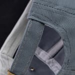 Close-up view of the adjustable grey fabric strap on the back of a baseball cap, showing the textured canvas material and stitching.