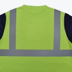 The back of a neon green high-visibility safety shirt with silver reflective stripes and navy blue sleeves.