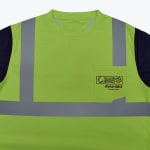 A high-visibility lime green safety t-shirt with navy blue sleeves, reflective silver stripes, and a chest pocket featuring the black logo.