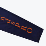 A close-up shot of a navy blue sleeve with 'ndsPRO' printed in orange letters.