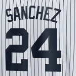 The back of a white pinstripe baseball jersey showing the name SANCHEZ and the number 24 in navy blue.