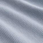 Close-up view of a light blue-grey ribbed knit fabric with soft folds and visible texture.