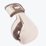 A side-angle view of a beige and brown Addos 12 oz boxing glove against a plain white background.