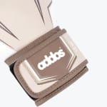 Close-up of a beige and brown boxing glove wrist strap with the addos logo and 12 oz label.