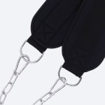 Close-up of a black padded dip belt with silver metal D-rings, carabiners, and chains on a white background.