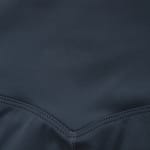 Close-up of dark grey athletic fabric with a V-shaped flatlock seam at the bottom.