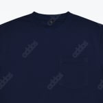 Close-up of a navy blue crewneck t-shirt with a subtle repeating addos logo pattern and a chest pocket.