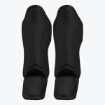A pair of matte black shin and instep guards for martial arts, displayed vertically side-by-side against a plain white background.