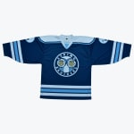 A navy blue hockey jersey with a circular logo in the center reading Eskimo Brothers featuring two cartoon characters in parkas. The jersey has light blue and white stripes on the sleeves and hem.