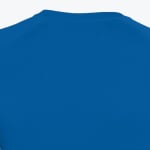 Close-up of the back neckline of a royal blue athletic shirt with raglan sleeves.